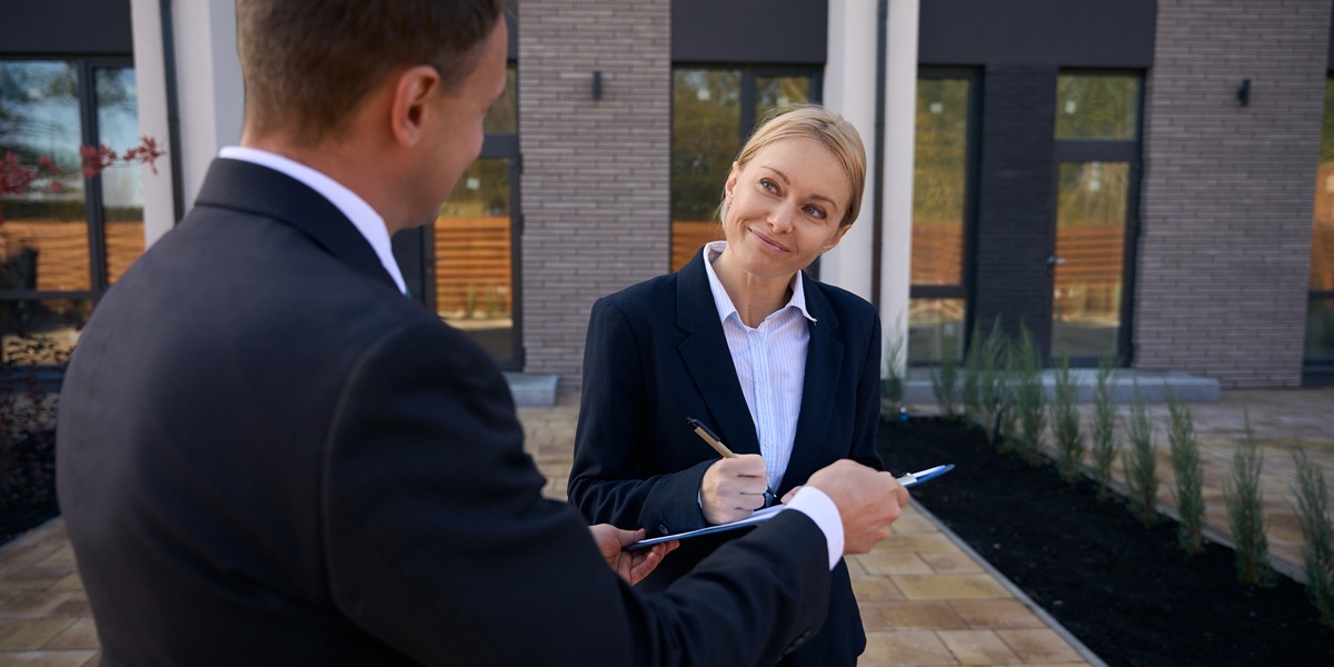 Female commercial property owner signing property management agreement