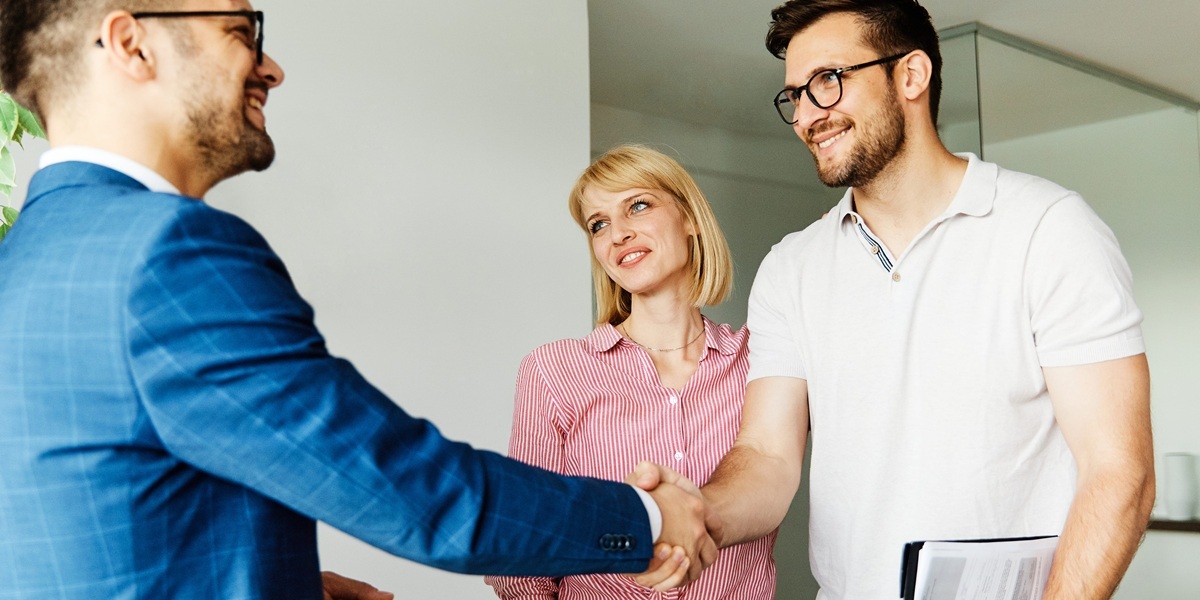 Property manager shaking hands with prospective renters