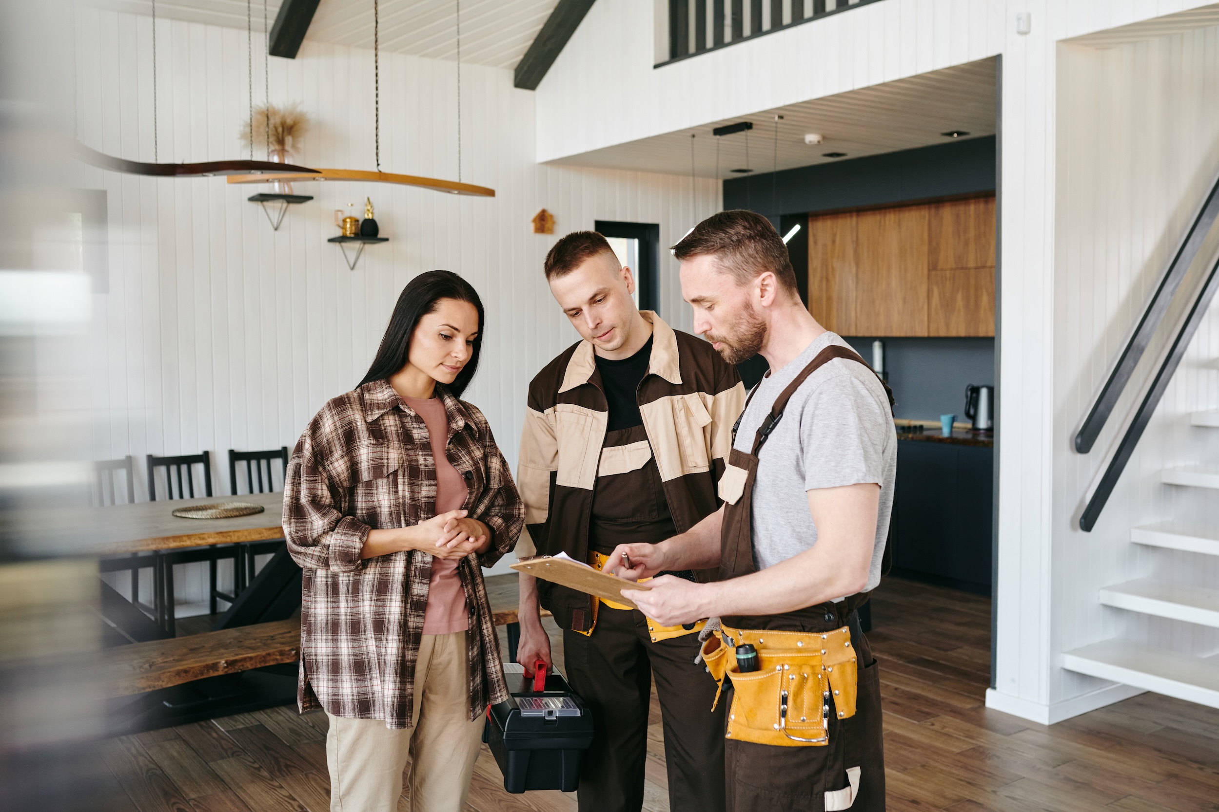 Northern California landlord discussing rental repairs with two maintenance workers. 