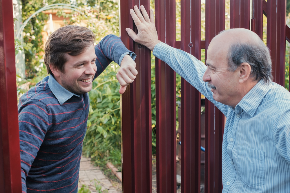 This image features an owner and tenant in an owner-occupied rental property speaking to one another.